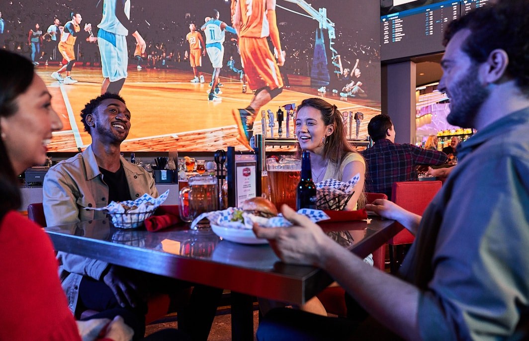 group of people being served food at a sports bar