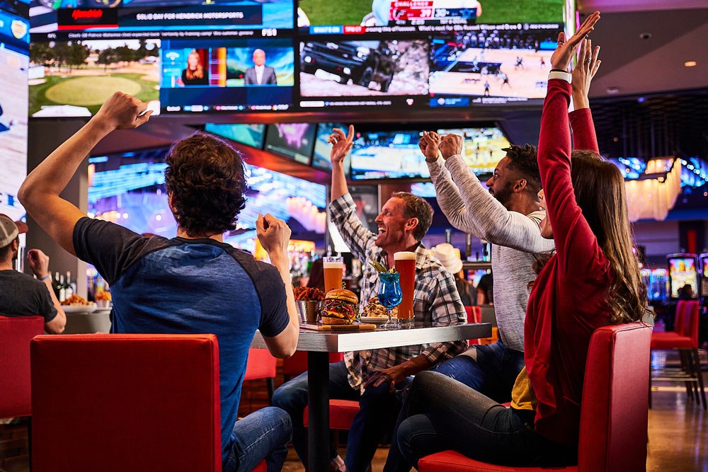 people cheering at a sports bar